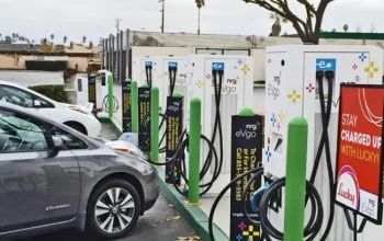 Two cars parked at an electric car charging station.